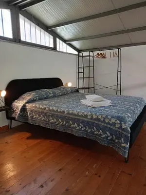 a bedroom with a bed in a room at DELIGHTFUL LOFT IN PlGNETO in Rome