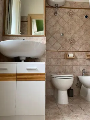 a bathroom with a sink and a toilet at Alloggio di Raffaello L in Rome
