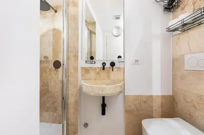 a bathroom with a sink and a shower at Bottega Augustea Duplex apartment in Monti in Rome