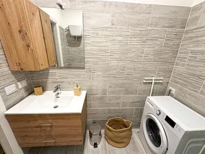 a bathroom with a sink and a washing machine at Giulio Cesare 237 in Rome