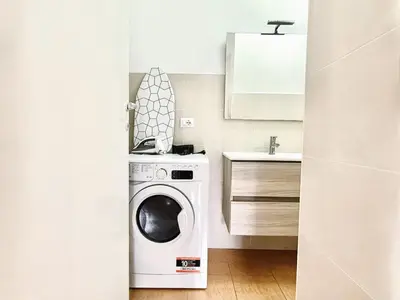 a kitchen with a washing machine and a sink at Bella Boutique in Rome