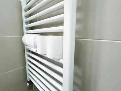 a towel rack with rolls of toilet paper in a bathroom at Bella Boutique in Rome