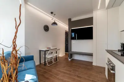 a living room with a blue couch and a table at GuestHost - Monteverde Classy Apartment in Rome