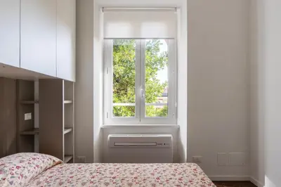 a bedroom with a bed and a window at GuestHost - Monteverde Classy Apartment in Rome