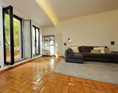 a living room with a couch and some windows at Vatican Luxury Apt with Garden in Rome