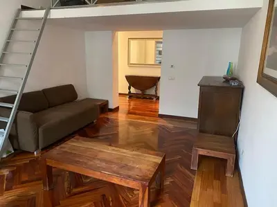 a living room with a couch and a stair case at Roma Termini Barbara House in Rome