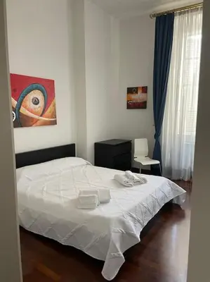 a bedroom with a bed and a painting on the wall at Roma Termini Barbara House in Rome