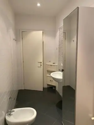 a white bathroom with a toilet and a sink at Roma Termini Barbara House in Rome