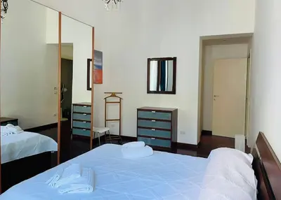 a bedroom with two beds and a mirror at Roma Termini Barbara House in Rome