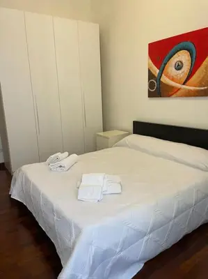 a bedroom with a white bed with towels on it at Roma Termini Barbara House in Rome
