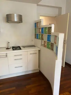 a small kitchen with white cabinets and a stove at Roma Termini Barbara House in Rome