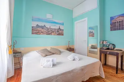 a bedroom with a large bed with a painting on it at Vatican Rooms Haven in Rome