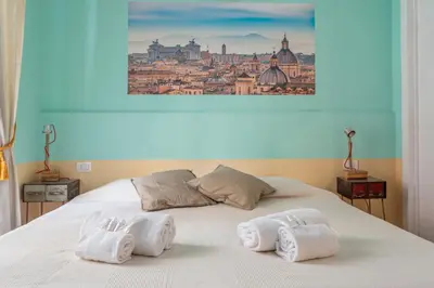 a kitchen with blue tiles on the wall at Vatican Rooms Haven in Rome