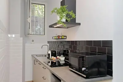 a kitchen with a sink and a microwave at Ostiense upsidedown in Rome