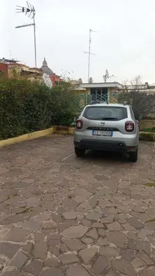 a small silver car parked in a parking lot at Imperial Rome Accommodation terrazza sul vaticano in Rome