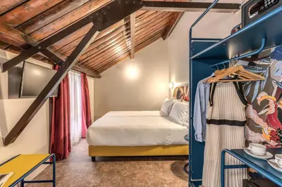 a bedroom with a bed in a room with wooden ceilings at Hotel XX Settembre in Rome