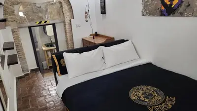 a bedroom with a bed with black and white pillows at Antica Trasteverina in Rome