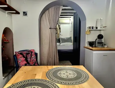 a room with a table and a room with a bedroom at Antica Trasteverina in Rome