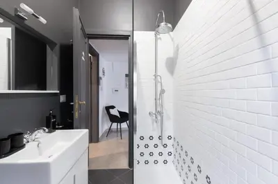 a white bathroom with a sink and a shower at Caracalla garden House in Rome
