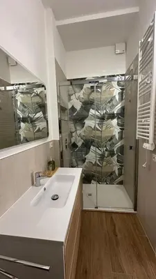 a bathroom with a white sink and a shower at A casa di Ren in Rome