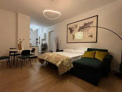 a bedroom with a bed and a table and chairs at A casa di Ren in Rome