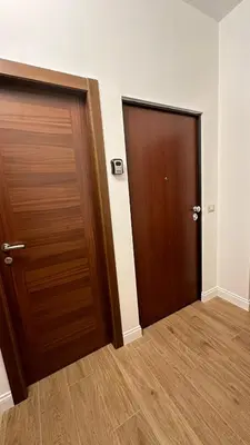 two doors in an empty room with wood floors at A casa di Ren in Rome