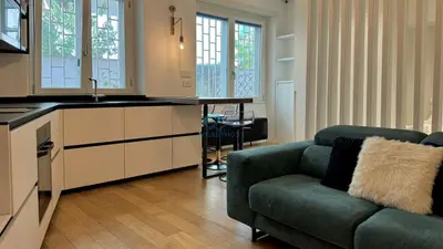 a living room with a couch and a kitchen at Chic Studio in piazza Bologna in Rome