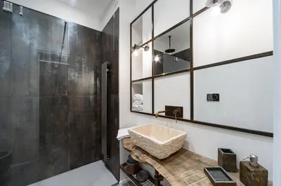a bathroom with a sink and a shower at Trastevere Luxury, ampia e confortevole location sospesa tra design e storia in Rome