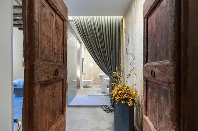an entrance to a bathroom with an open door at Trastevere Luxury, ampia e confortevole location sospesa tra design e storia in Rome