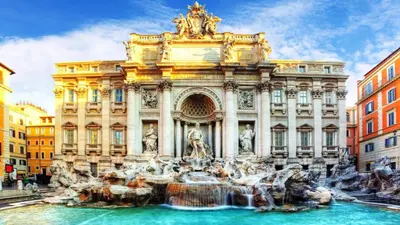a building with a fountain in front of a building at Luxury Apartment Via Veneto in Rome