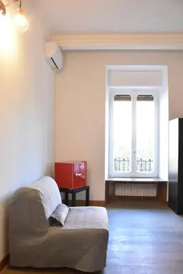 a living room with a couch and a window at Giulia Mesa Suites in Rome