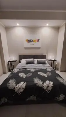 a bedroom with a bed with a black and white blanket at Holiday Space Roma in Rome