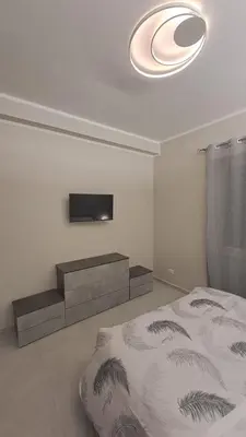 a bedroom with a bed and a flat screen tv at Holiday Space Roma in Rome