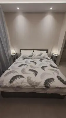 a bed with a comforter on it in a bedroom at Holiday Space Roma in Rome