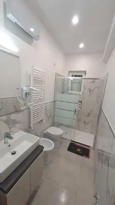 a bathroom with a toilet and a sink and a shower at Holiday Space Roma in Rome