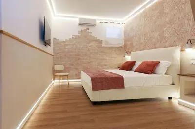 a bedroom with a bed and a brick wall at The Brick Apartment by Nosdom Properties in Rome