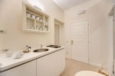 a white bathroom with a sink and a toilet at Elegant Flat Spanish steps in Rome