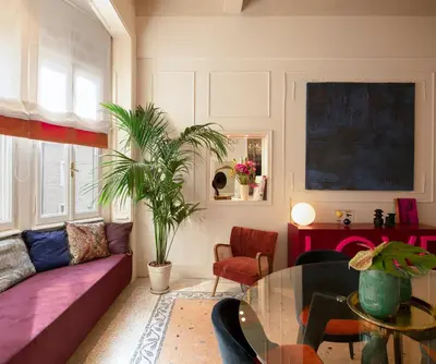 a living room with a purple couch and a glass table at Elizabeth Unique Apartments - a Member of Design Hotels in Rome