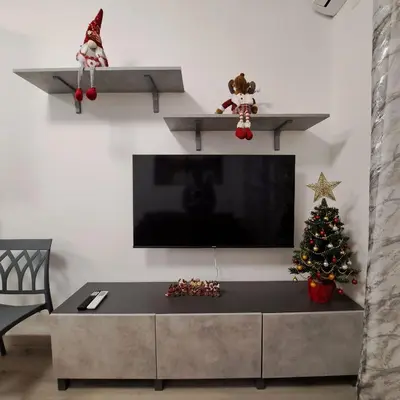 a living room with a tv and a christmas tree at Le tue vacanze a Roma-2 bagni-nuovo apt in Rome