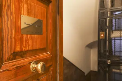 a wooden door with a picture on it at Piramide Deluxe Apartment in Rome