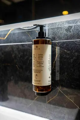 a bottle of soap sitting on top of a counter at Home at Rome Luxury Navona Suites in Rome