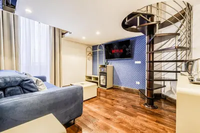 a living room with a couch and a tv at Home at Rome Luxury Navona Suites in Rome