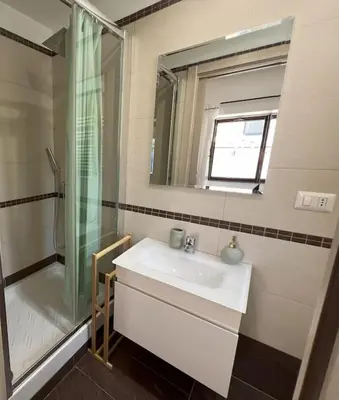 a bathroom with a sink and a shower at Urban Retreat in Rome