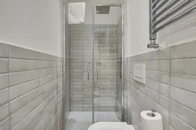 a bathroom with a toilet and a glass shower at Domus Capitolina Campo De' Fiori in Rome