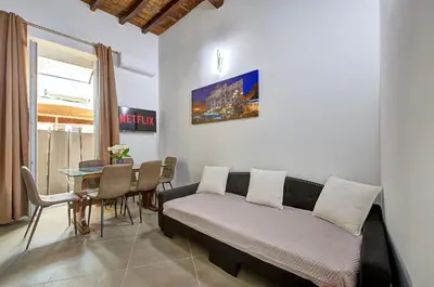 a living room with a couch and a table at Domus Capitolina Campo De' Fiori in Rome