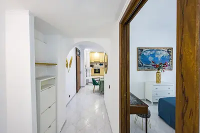 a hallway leading to a kitchen and a living room at Apartment Metro San Paolo -Air Conditioning-WIFI-TV55