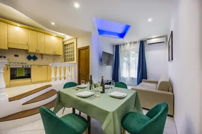 a kitchen and a living room with a table and chairs at Apartment Metro San Paolo -Air Conditioning-WIFI-TV55