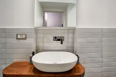 a bathroom with a large white sink on a wooden table at Domus Capitolina Pantheon in Rome