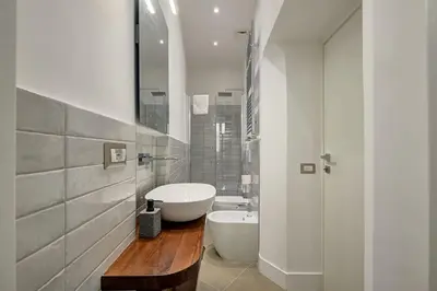 a white bathroom with a sink and a tub at Domus Capitolina Pantheon in Rome