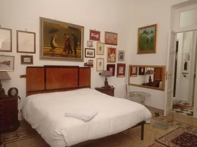 a bedroom with a bed and a painting on the wall at Fiore73 in Rome